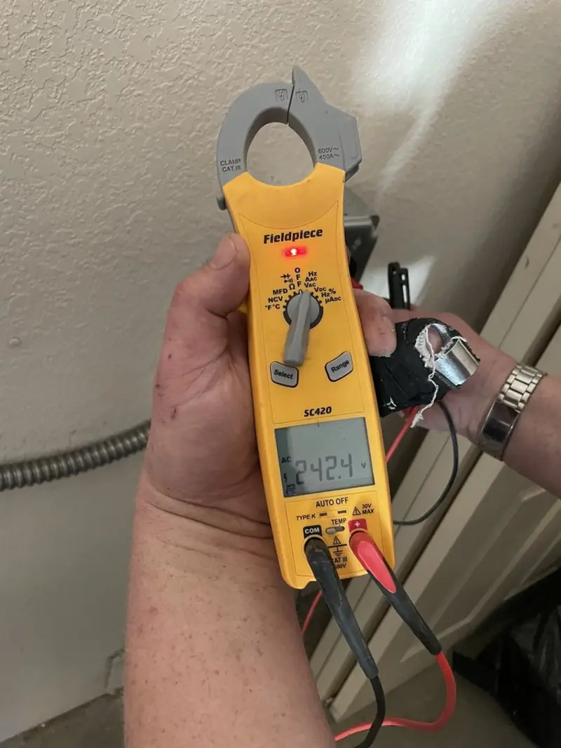 Voltage testing with clamp meter during Outlet Installation in Brentwood